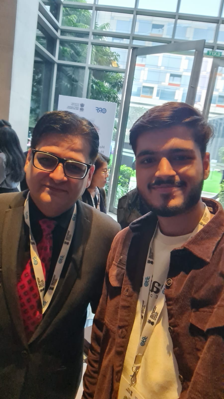 Akshat Mehrotra standing with the Vice President of a Think Tank.